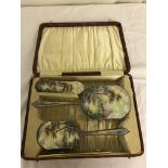 A cased gilt and enamelled dressing set