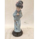 A Lladro Geisha girl, No 4989 CONDITION REPORT: Has damage to one flower to her hair,