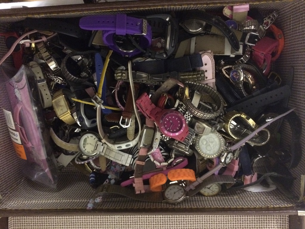 A large quantity of watches in suitcase