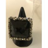 An 18ct dress ring: diamond and onyx