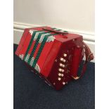 A Hohner concertina in a soft case