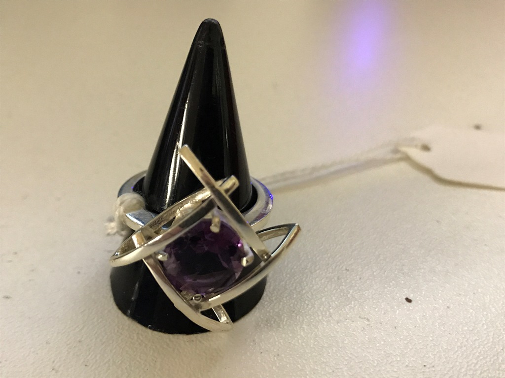 A silver abstract amethyst dress ring