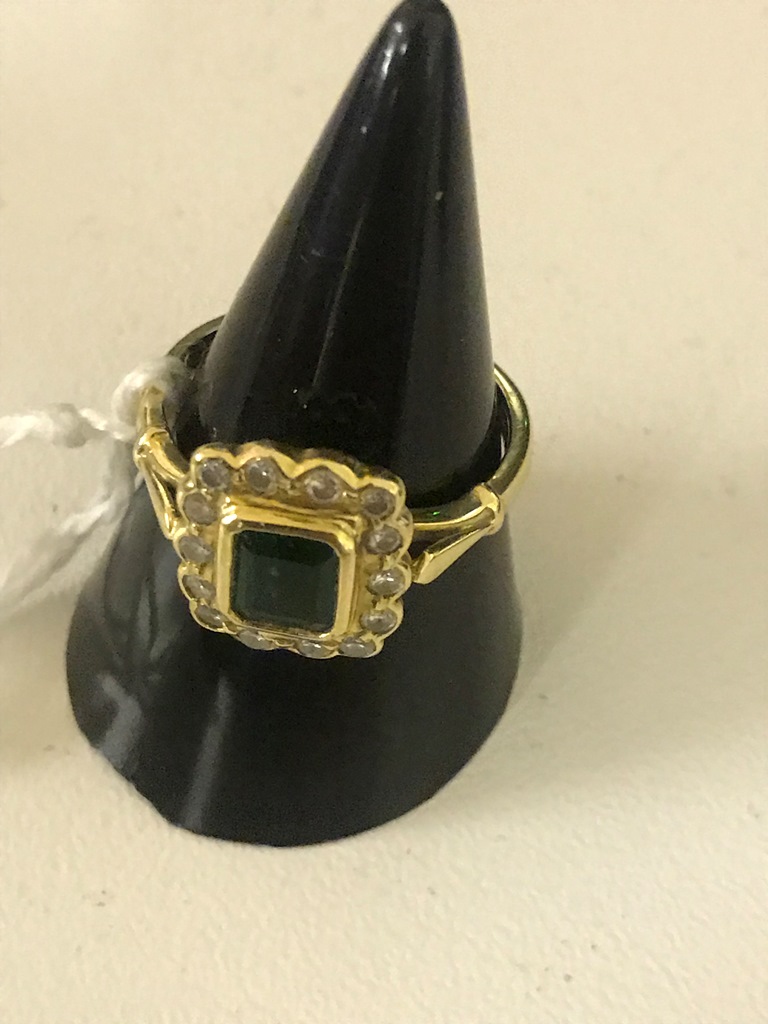 An 18ct emerald and diamond dress ring