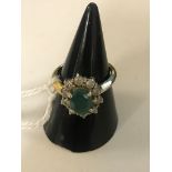An 18ct diamond and emerald ring