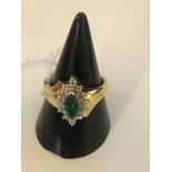 An 18ct green stone and diamond ring