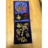 A quantity of Victorian and later badges, buttons, embroidered trench art etc.