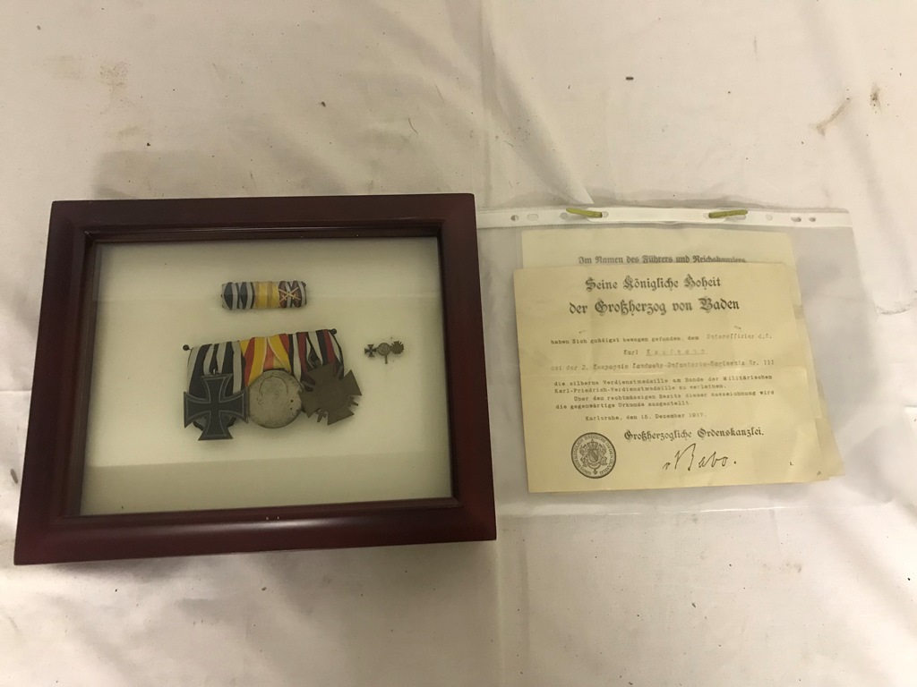 Cased WWI Iron Cross group of three medals with miniatures and paperwork.