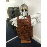 Roman Helmet, leather jerkin and under garment on a stand.