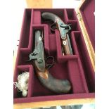 A pair of 19th century R S Clark percussion pistols,