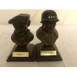 Carved wood General Patton and Monty busts.