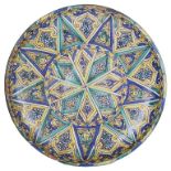 A Charger: 17th/18th century, Persian, decorated in a geometric design amongst scrolls,