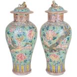 A pair of Chinese famille rose vases with domed lids: 19th century,