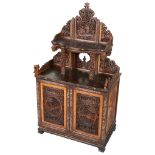 A Chinese Cabinet: Carved throughout with figural and garden scenes,
