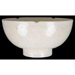 A Chinese glazed bowl: With lobed rim and incised floral decoration to the exterior.