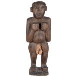 Two African Wooden Carvings: One of a man with clasped hands standing on a square shaped base,