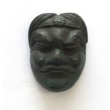 A Japanese bronze okimono: Meiji period, carved as a miniature theatre mask,