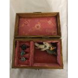 A jewellery box with three silver rings,