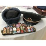 Three Eastern European hats to include one with badges