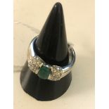 An 18ct emerald and diamond dress ring