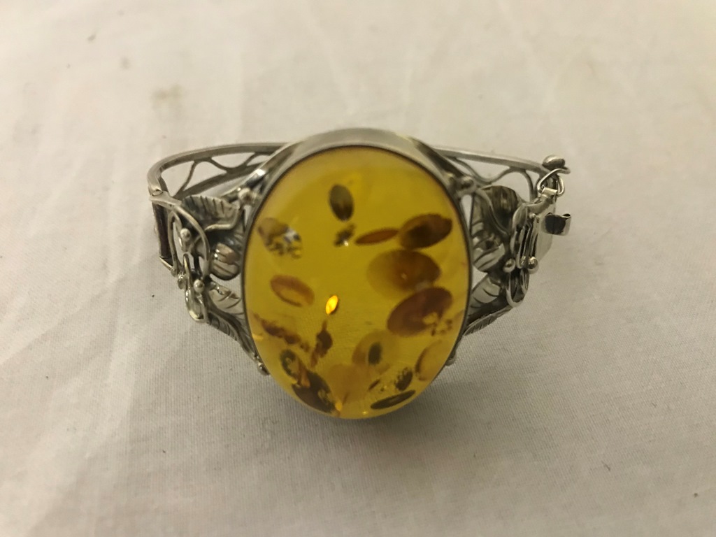 A silver bangle with amber