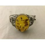 A silver bangle with amber