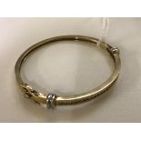 A 9ct gold bangle with 1ct of channel set diamonds