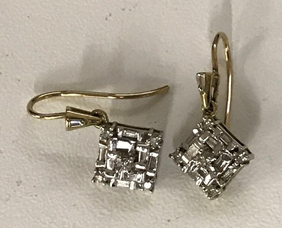 Diamond earrings set with baguette and brilliant cut