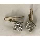 Diamond earrings set with baguette and brilliant cut