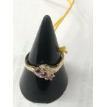 A 9ct gold three-stone amethyst and diamond ring