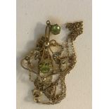 An Edwardian peridot and pearl pendant on chain