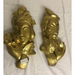 A pair of gilt plaster plaques depicting an Oriental man and lady