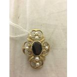A gold pearl and garnet brooch