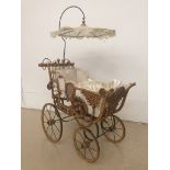 A Victorian-style child's doll pram and parasol