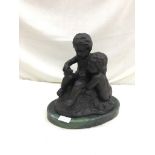 A bronze figure of twin putti on a serpentine base