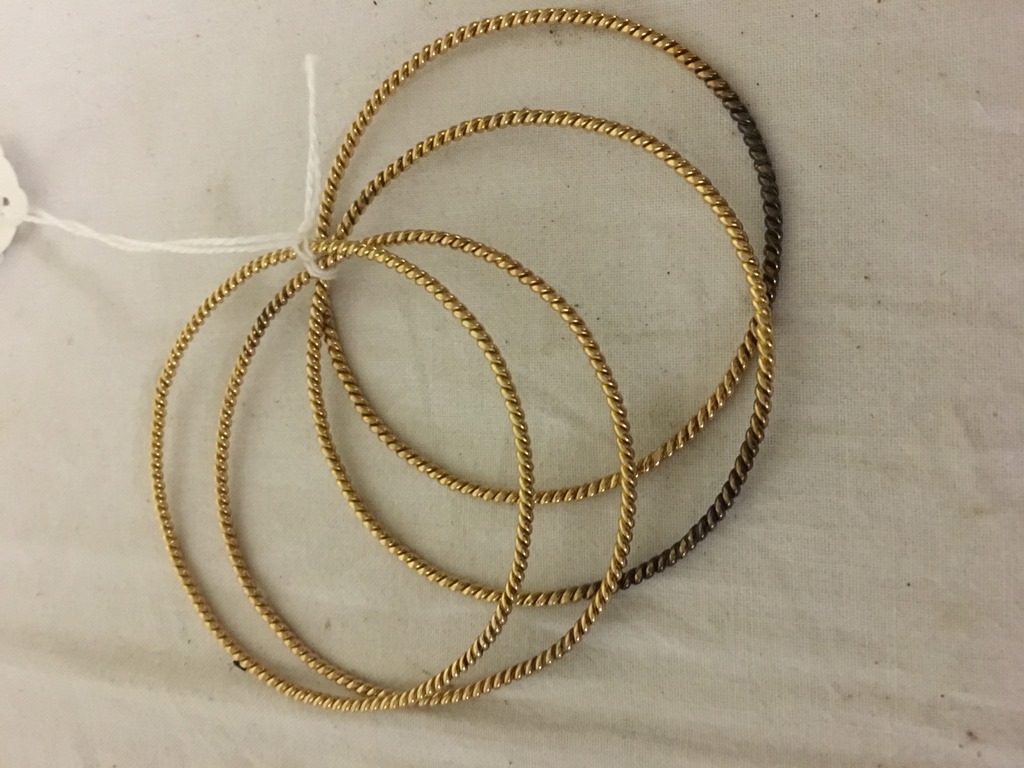 Four gold bangles