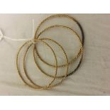 Four gold bangles