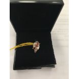 A 9ct gold three-stone garnet and diamond ring