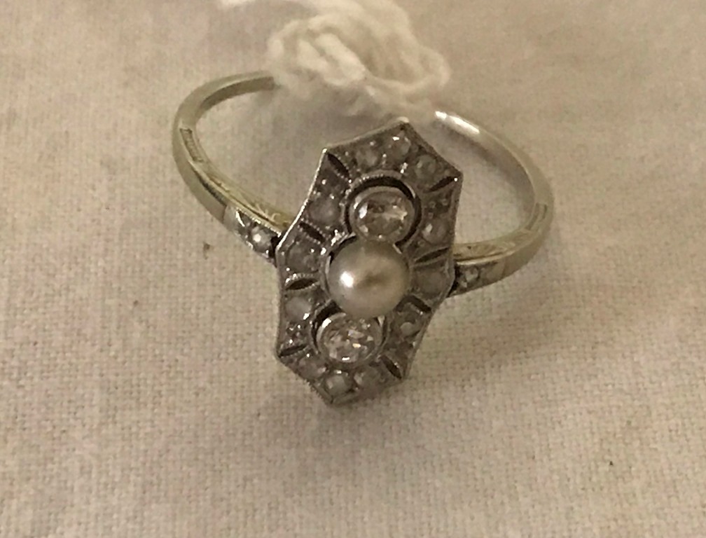 An unmarked pearl and diamond ring