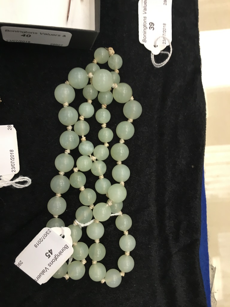 A graduated jade bead necklace of good translucent celadon colour, no clasp,