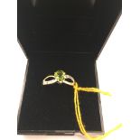 A 9ct gold pear-cut peridot and diamond ring