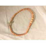 A 9ct pearl clasped string of coral beads