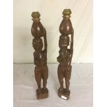 A pair of ethnic carved candlesticks