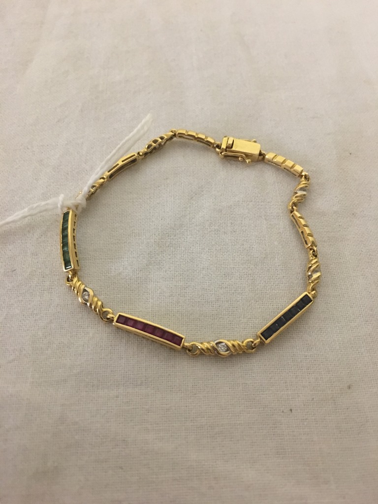 A gold bracelet set with blue,