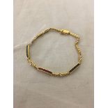 A gold bracelet set with blue,