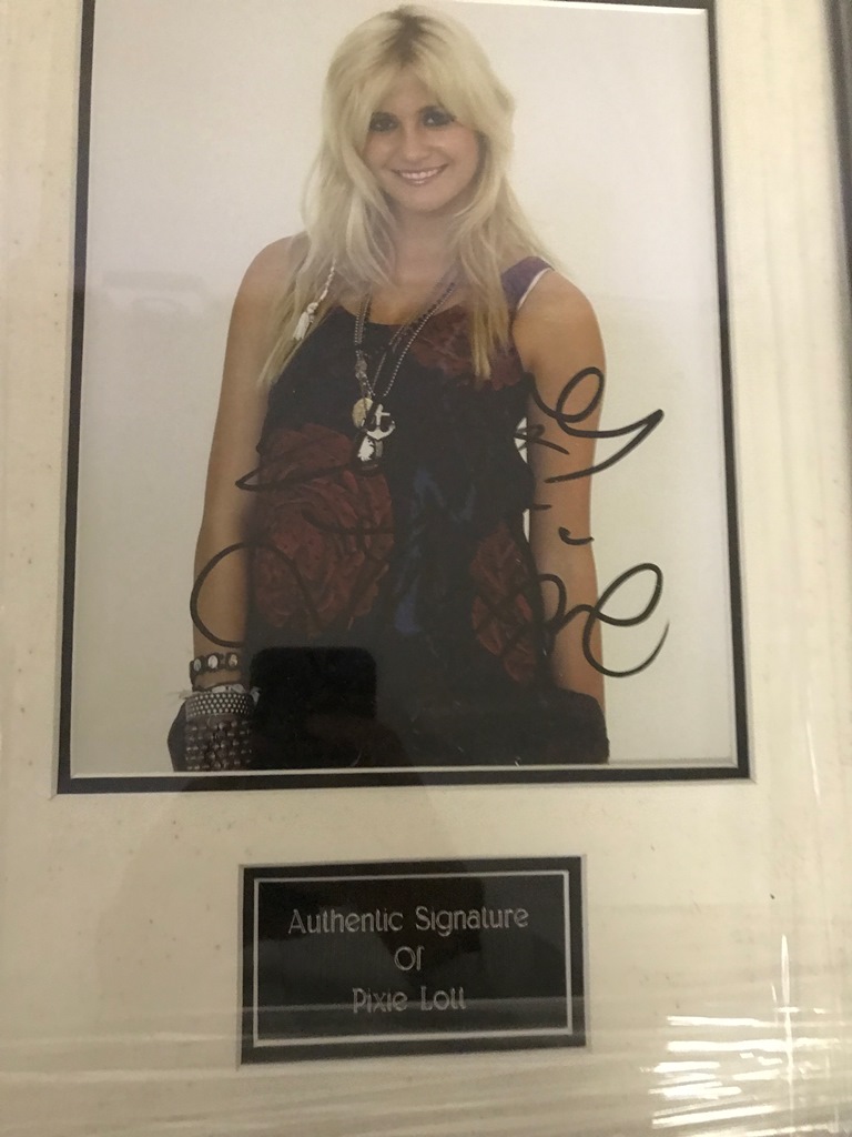 A framed and glazed signed photograph of Pixie Lott (with COA)