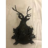 A bronze wall plaque in the form of a stag