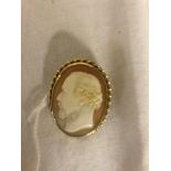 A carved cameo in an unhallmarked 9ct mount by J Ronca,