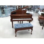 A mahogany baby grand piano;