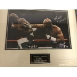 A framed and glazed signed photograph of Evander Holyfield (with COA)