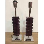 A pair of chrome lamps with amethyst colour glass,